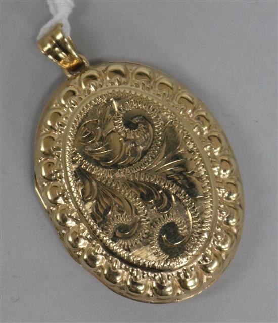A 1970s engraved 9ct. gold locket, overall 4.5cm.